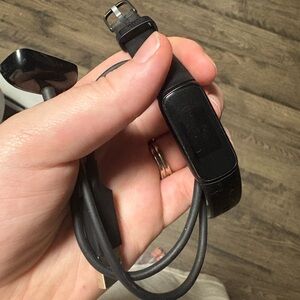 Black Fitbit luxe watch with Charger